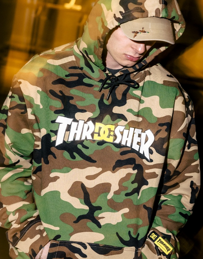 A man wearing a DC Thrasher collaboration camo hoodie