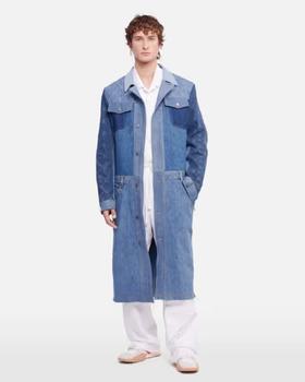 A man wearing a denim overcoat by Marine Serre and white pants and button ups