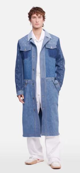 A man wearing a denim overcoat by Marine Serre and white pants and button ups