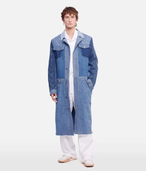A man wearing a denim overcoat by Marine Serre and white pants and button ups