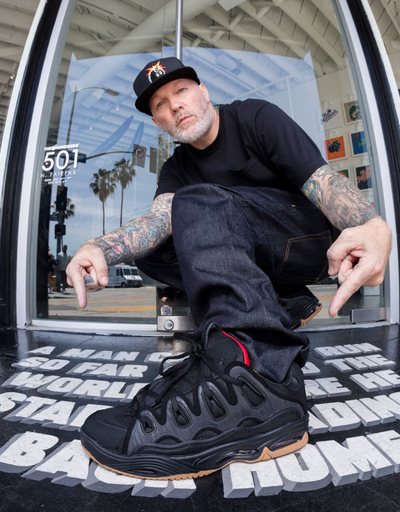 A man close up of a man wearing Osiris skateshoes in black and red