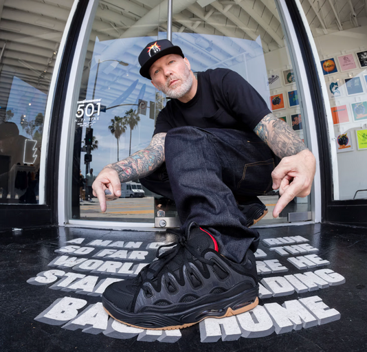 A man close up of a man wearing Osiris skateshoes in black and red
