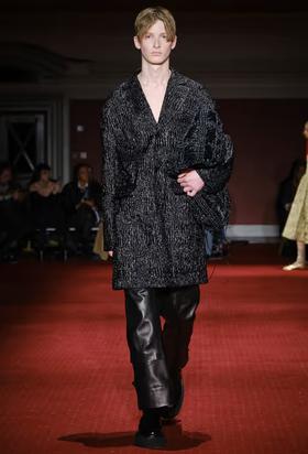A man wearing a Simone Rocha black outfit with leather pants