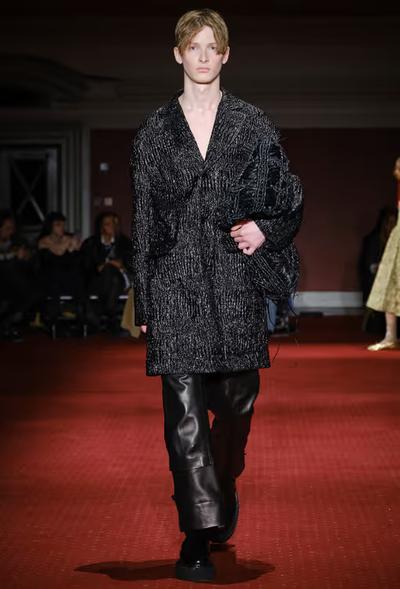 A man wearing a Simone Rocha black outfit with leather pants