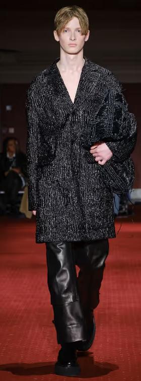 A man wearing a Simone Rocha black outfit with leather pants