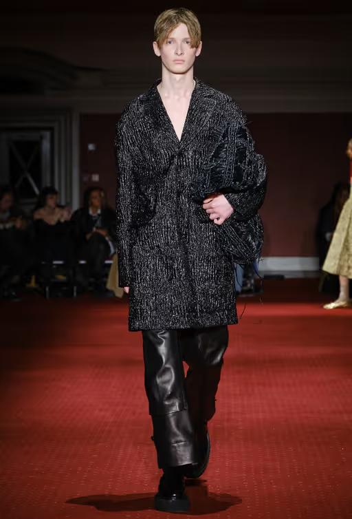 A man wearing a Simone Rocha black outfit with leather pants