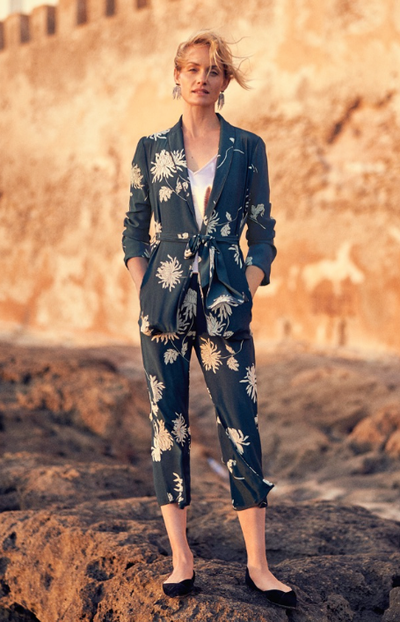 A woman wearing a floral Anthropologie jumper in navy blue