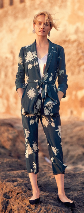 A woman wearing a floral Anthropologie jumper in navy blue