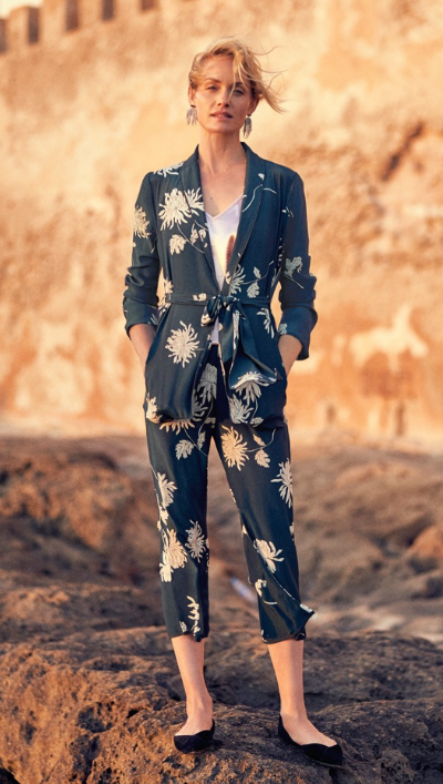 A woman wearing a floral Anthropologie jumper in navy blue