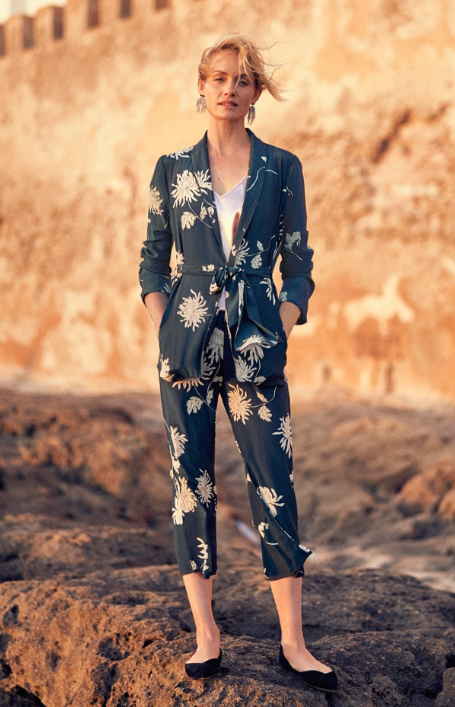 A woman wearing a floral Anthropologie jumper in navy blue