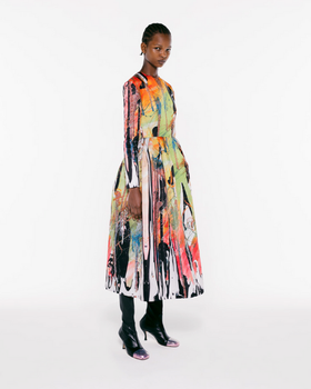 A womman wearing a colorful floral dress by Christopher Kane