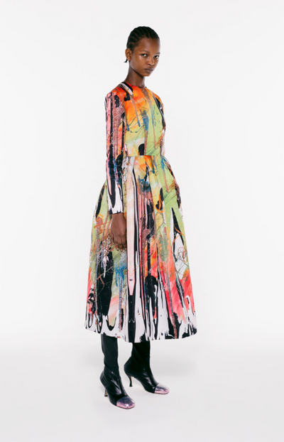 A womman wearing a colorful floral dress by Christopher Kane