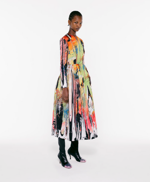 A womman wearing a colorful floral dress by Christopher Kane