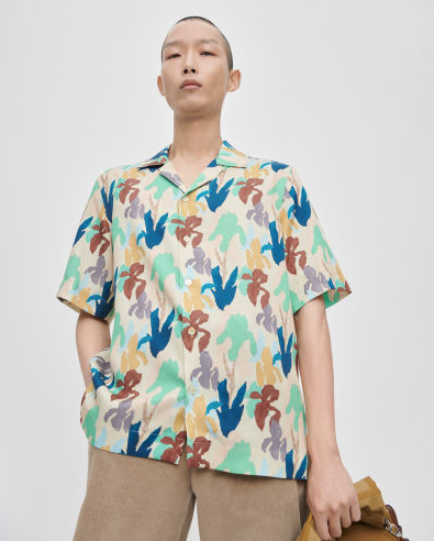A man wearing a colorful print Paul Smith short-sleeve button up