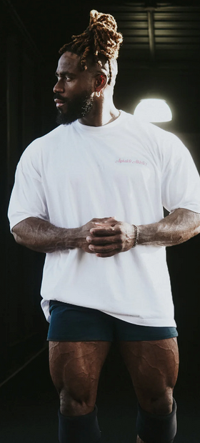 A man wearing a Alphalete white t-shirt with short shorts