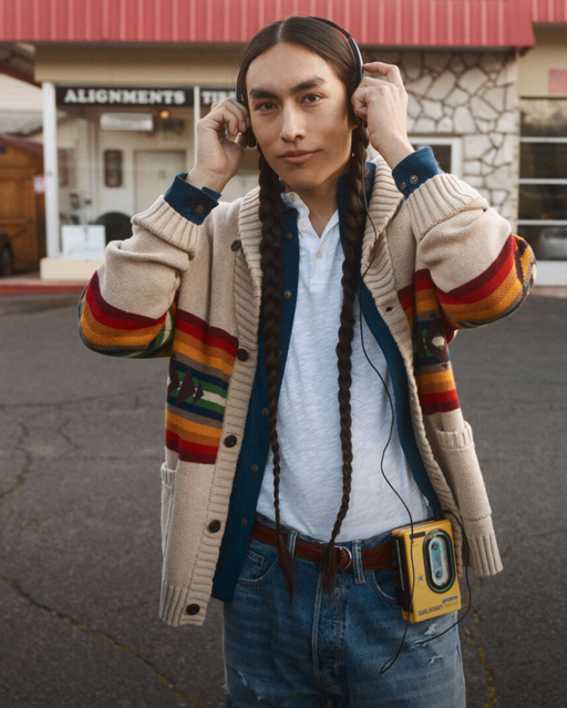 A man wearing a Pendleton brown sweater with jeans