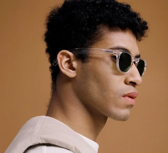 A man wearing a izipizi clear sunglasses