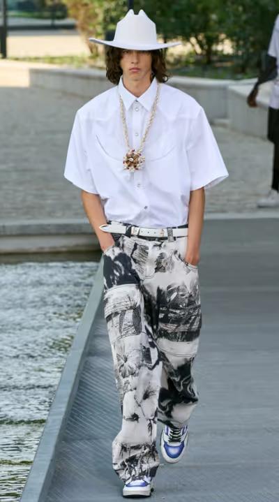 A man wearing a MSGM white short-sleeve, a cowboy pants and wide pants