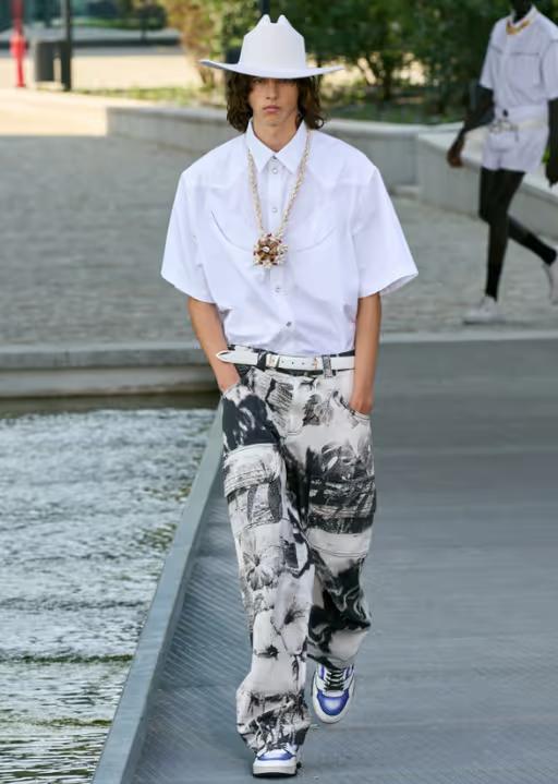 A man wearing a MSGM white short-sleeve, a cowboy pants and wide pants