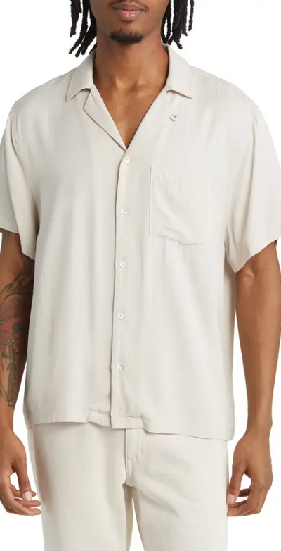 A man wearing an Elwood cream short-sleeve and matching pants