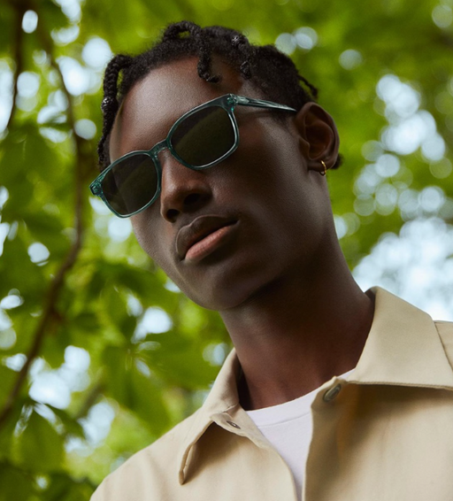 a man wearing a Warby Parker green sunglasses