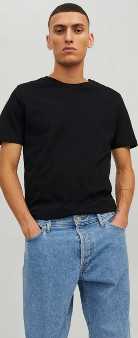 A man wearing a black Jack & Jones t-shirt with blue washed jeans