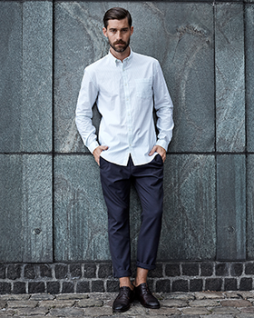 A man wearing a white button up and dress slacks by Selected Homme