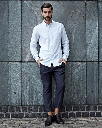 A man wearing a white button up and dress slacks by Selected Homme