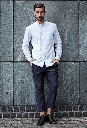 A man wearing a white button up and dress slacks by Selected Homme