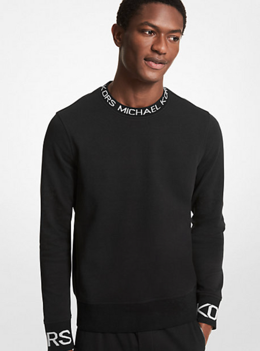 A man wearing a Michael Kors branded black long-sleeve