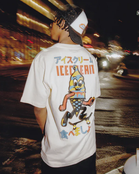 A man wearing an Ice Cream / Billionaire Boys Club white t-shirt with a graphic-forward colors