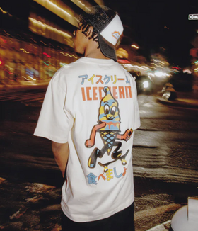 A man wearing an Ice Cream / Billionaire Boys Club white t-shirt with a graphic-forward colors