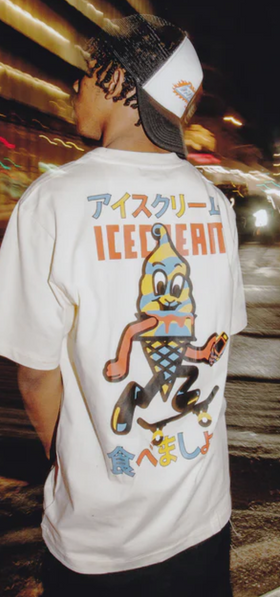 A man wearing an Ice Cream / Billionaire Boys Club white t-shirt with a graphic-forward colors