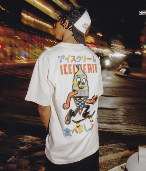 A man wearing an Ice Cream / Billionaire Boys Club white t-shirt with a graphic-forward colors