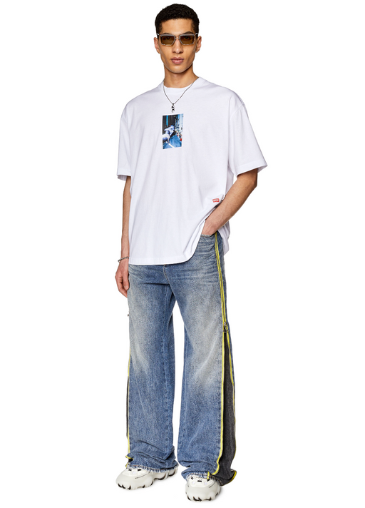 A man wearing a white Diesel t-shirt and jeans