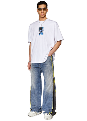 A man wearing a white Diesel t-shirt and jeans