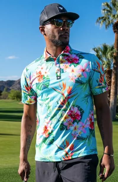 A man wearing a Bad Birdie floral golf shirt with a black hat