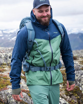 A man wearing a Bergans of Norway green and blue winter jacket and matching pants
