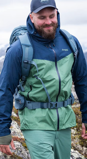 A man wearing a Bergans of Norway green and blue winter jacket and matching pants