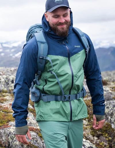 A man wearing a Bergans of Norway green and blue winter jacket and matching pants