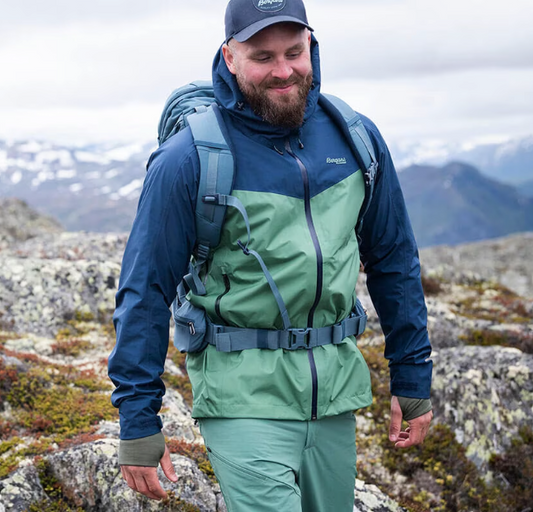 A man wearing a Bergans of Norway green and blue winter jacket and matching pants