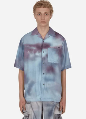 A man wearing a OAMC faded blue button up with matching cargo pants