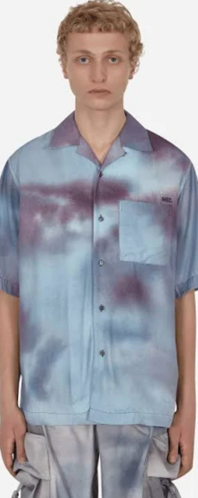A man wearing a OAMC faded blue button up with matching cargo pants