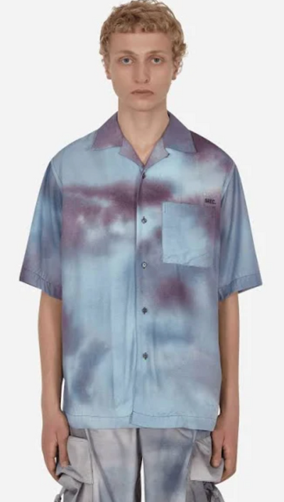 A man wearing a OAMC faded blue button up with matching cargo pants
