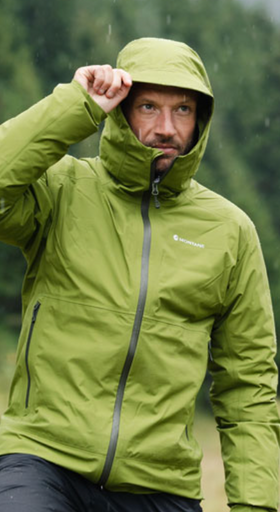 A man wearing a green Montane winter jacket with the hood on