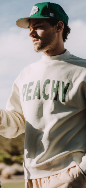 A man wearing a Devereux Golf grey 'Peachy' sweater and green hat