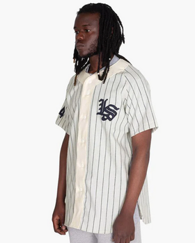 A man wearing a Livestock baseball jersey