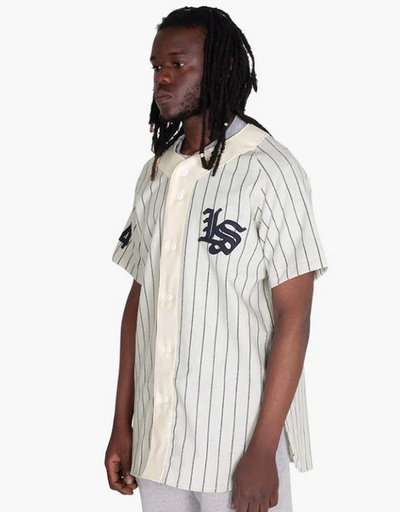 A man wearing a Livestock baseball jersey