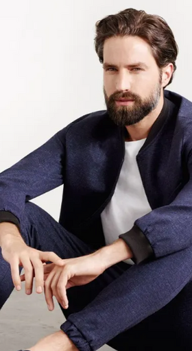 A man wearing a Superga casual suit with a white shirt underneath
