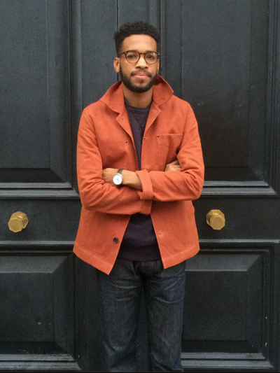 A man wearing an orange Albam overshirt with dark washed jeans